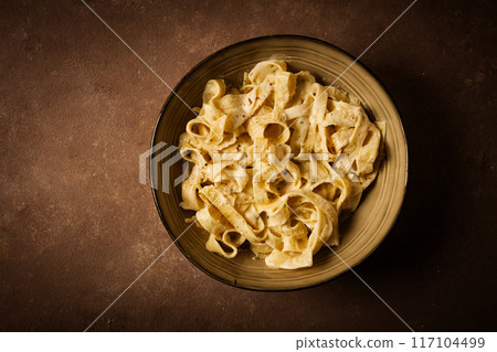Fettuccine, tagliatelle, in creamy garlic sauce, Italian traditional cuisine, pasta carbonaro, Fettuccine, tagliatelle, in creamy garlic sauce, Italian traditional cuisine, pasta carbonaro, 117104499