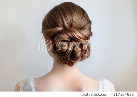 Sophisticated and chic bridal updo hairstyle with creative textured bun. Intricate lace detail and elegant twist for a formal wedding event Sophisticated and chic bridal updo hairstyle with creative textured bun. Intricate lace detail and elegant twist for a formal wedding event 117104638