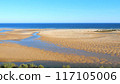 Cacela Velha beach in Algarve, Portugal, Ria Formosa Natural Park. Vibrant blue ocean, expansive golden sands, and unique tidal formations. Ideal for summer beach vacations.  117105006