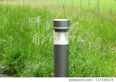Waterproof landscape light on summer green lawn background 117106324
