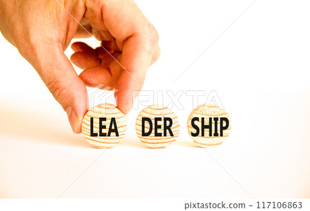 Leadership symbol. Concept word Leadership on beautiful wooden circles. Beautiful white table white background. Businessman hand. Business leadership concept. Copy space. Leadership symbol. Concept word Leadership on beautiful wooden circles. Beautiful white table white background. Businessman hand. Business leadership concept. Copy space. 117106863
