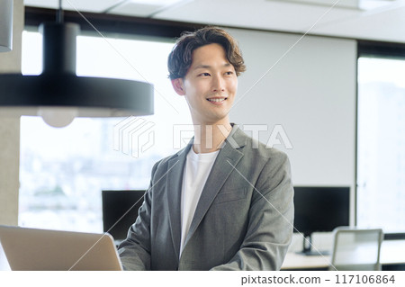 Japanese male businessman (talking to a colleague) Japanese male businessman (talking to a colleague) 117106864