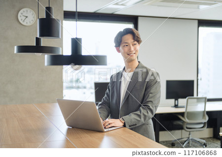 Japanese male businessman (talking to a colleague) Japanese male businessman (talking to a colleague) 117106868