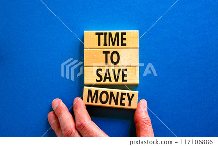 Time to save money symbol. Concept words Time to save money on wooden blocks on a beautiful blue table blue background. Businessman hand. Business, finacial and time to save money concept. 117106886
