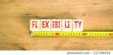 Flexibility symbol. Concept word Flexibility on beautiful wooden cubes. Beautiful wooden background. Beautiful yellow ruler. Business flexibility concept. Copy space. 117106916