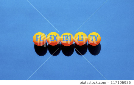 Flexibility symbol. Concept word Flexibility on beautiful yellow ping pong balls. Beautiful blue background. Business flexibility concept. Copy space. 117106926
