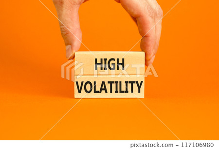 High volatility symbol. Concept words High volatility on beautiful wooden blocks. Beautiful orange table orange background. Businessman hand. Business high volatility concept. Copy space. High volatility symbol. Concept words High volatility on beautiful wooden blocks. Beautiful orange table orange background. Businessman hand. Business high volatility concept. Copy space. 117106980