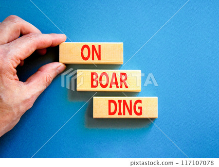 Onboarding success symbol. Concept word Onboarding on wooden blocks. Businessman hand. Beautiful blue background. Business onboarding success concept. Copy space. Onboarding success symbol. Concept word Onboarding on wooden blocks. Businessman hand. Beautiful blue background. Business onboarding success concept. Copy space. 117107078