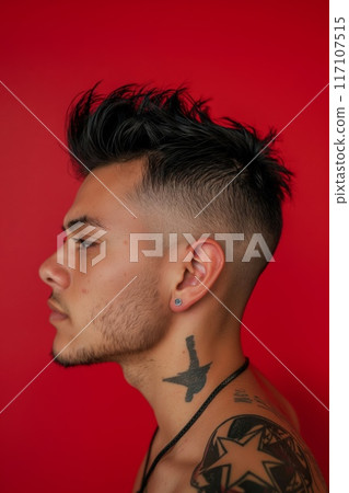 Side profile of a young adult showing off a modern faux hawk haircut with shaved sides against a red background 117107515
