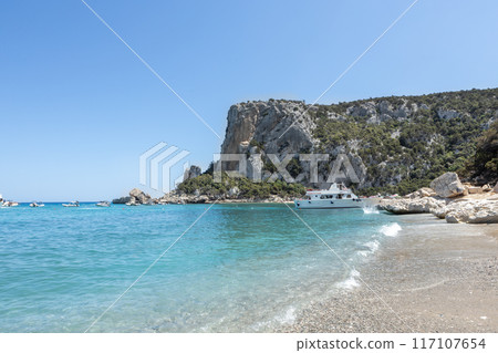 Turquoise Waters and Limestone Cliffs of Cala Luna Beach Turquoise Waters and Limestone Cliffs of Cala Luna Beach 117107654