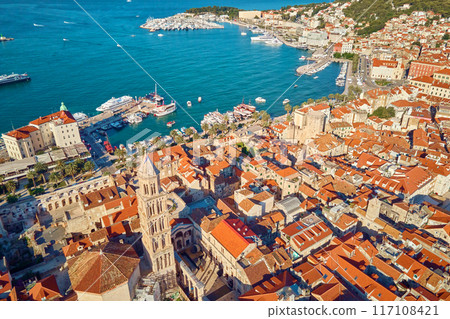 Aerial view of Split, Croatia. Cityscape of coastal touristic city with harbor. Old town with historical red roof tiled buildings near Adriatic Sea 117108421