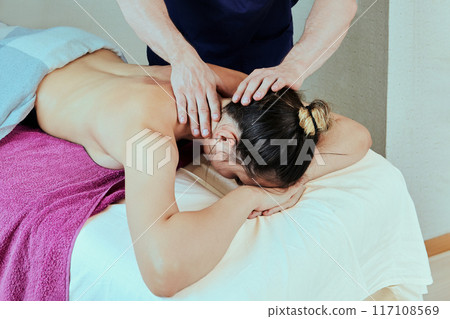 Massage therapy of neck pain, deep tissue massages for young woman. 117108569