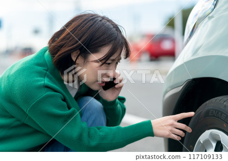 Woman calling about car trouble Woman in trouble after car accident Woman calling about car trouble Woman in trouble after car accident 117109133