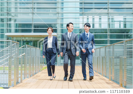 Full body of a business person moving through the office entrance 117110389
