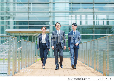 Full body of a business person moving through the office entrance 117110393
