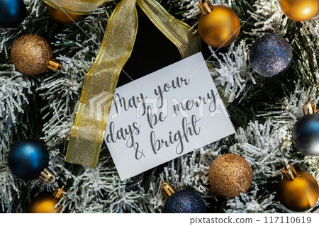 MAY YOUR DAYS BE MERRY AND BRIGHT text on postcard on handmade Christmas wreath. Zero waste eco-friendly Christmas. Sustainable greeting card 117110619