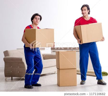 Two young contractor employees moving personal belongings 117110682