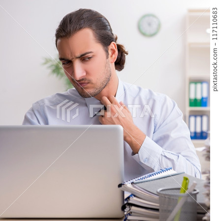 Young male businessman employee unhappy with excessive work 117110683