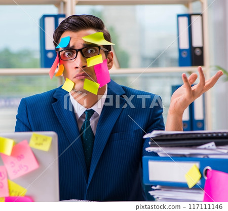 Businessman with reminder notes in multitasking concept 117111146
