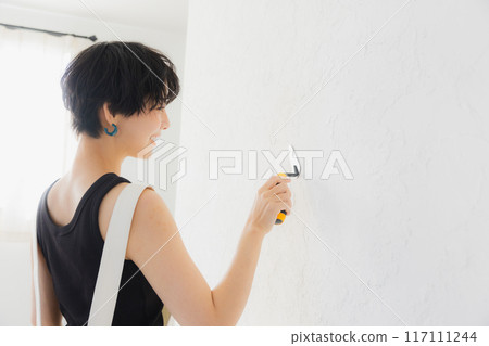 A woman with short hair doing DIY A woman with short hair doing DIY 117111244