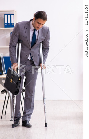 Leg injured employee in the office Leg injured employee in the office 117111654