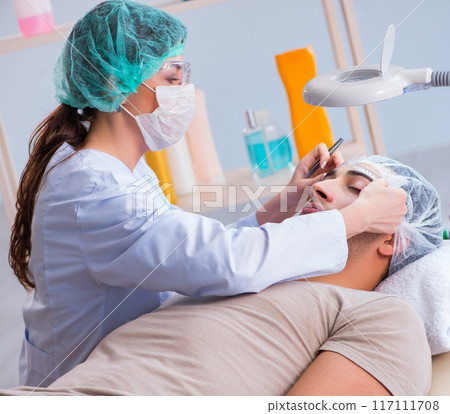 Young handsome man visiting female doctor cosmetologist 117111708
