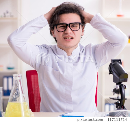 Young male biochemist working in the lab Young male biochemist working in the lab 117111714