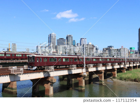 Hankyu train crossing the Yodo River iron bridge 117112354