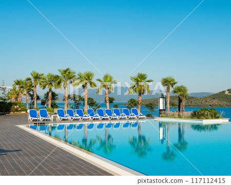Nice swimming pool outdoors on bright summer day 117112415