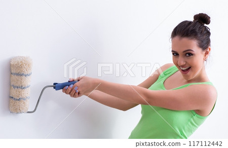 Young beautiful woman doing renovation at home Young beautiful woman doing renovation at home 117112442