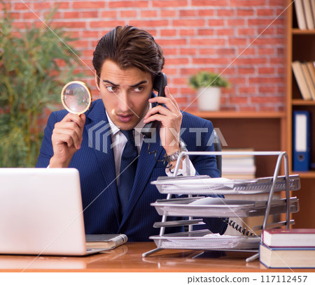 Young handsome lawyer working in his office Young handsome lawyer working in his office 117112457