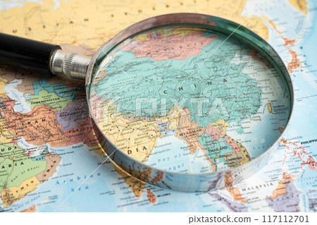 Bangkok, Thailand - June 15, 2024 China, Magnifying glass close up with colorful world map, travel, geography, tourism and exploration concept. 117112701