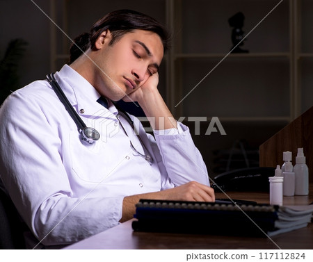 Young male doctor in the hospital at night 117112824