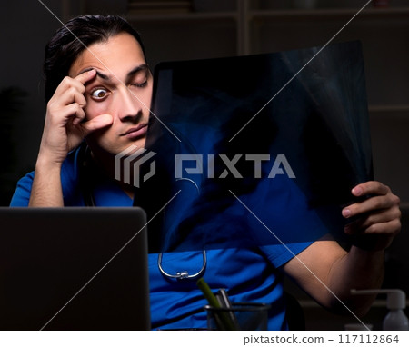 Young male doctor in the hospital at night 117112864