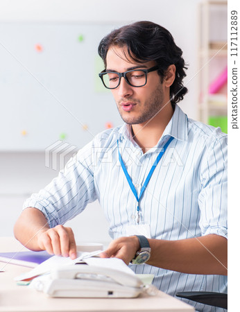 Young handsome male designer working in the office 117112889