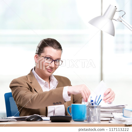Businesswoman working in the office Businesswoman working in the office 117113222