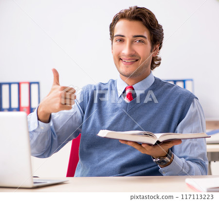 Young handsome employee working in the office Young handsome employee working in the office 117113223