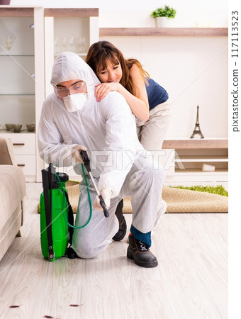 Young professional contractor doing pest control at flat Young professional contractor doing pest control at flat 117113523