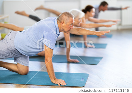Elderly man doing pilates in group 117115146