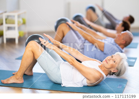 Elderly woman doing pilates with softball 117115199