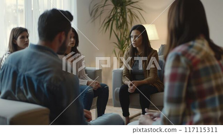 A group of diverse people are sitting on a couch and talking AIG535 117115311