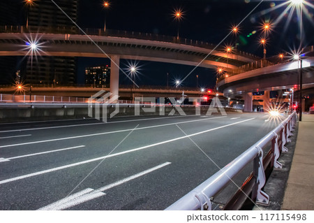 Glittering night view of a highway junction 117115498