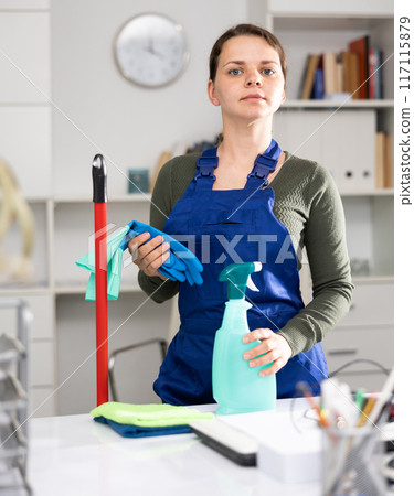 Waist-up portrait of woman in overall in office Waist-up portrait of woman in overall in office 117115879