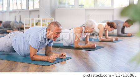 Elderly man doing pilates in group Elderly man doing pilates in group 117116065
