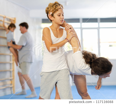 Mother and son training self-defense techniques 117116088