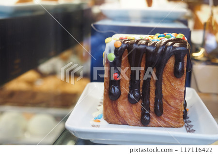 Indulgent and Deliciously Decadent Chocolate Drizzled Square Dessert Topped with Colorful Sprinkles Indulgent and Deliciously Decadent Chocolate Drizzled Square Dessert Topped with Colorful Sprinkles 117116422