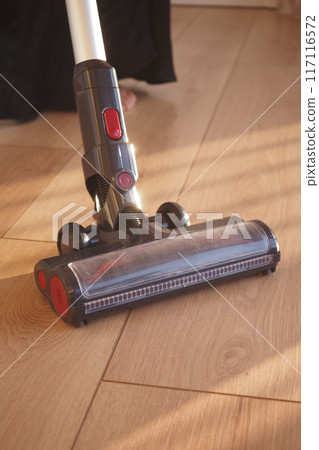 cleaning floor dust with vacuum cleaner. 117116572