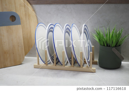 round bowl or ceramic plate on kitchen table. round bowl or ceramic plate on kitchen table. 117116618