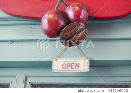 Open Sign with Cherry Decoration at a Cozy Caf Entrance 117116620