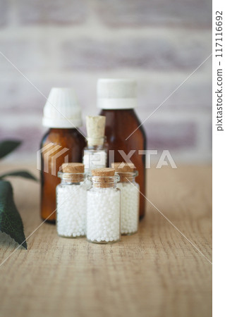 Homeopathic pills containers on a table  117116692